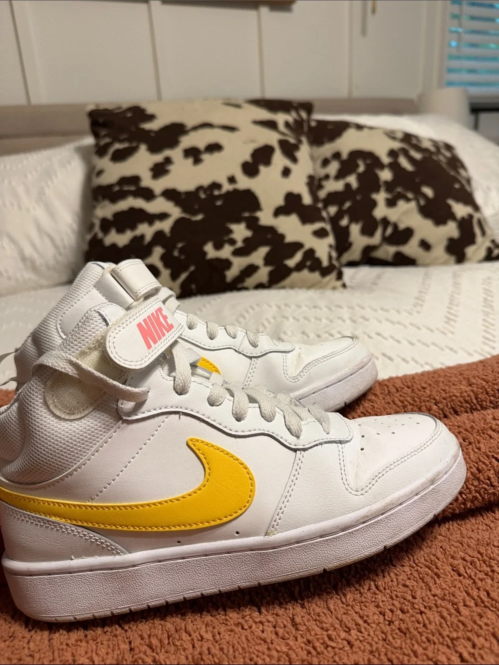Nike White Mid-Top Sneakers with Yellow Swoosh
